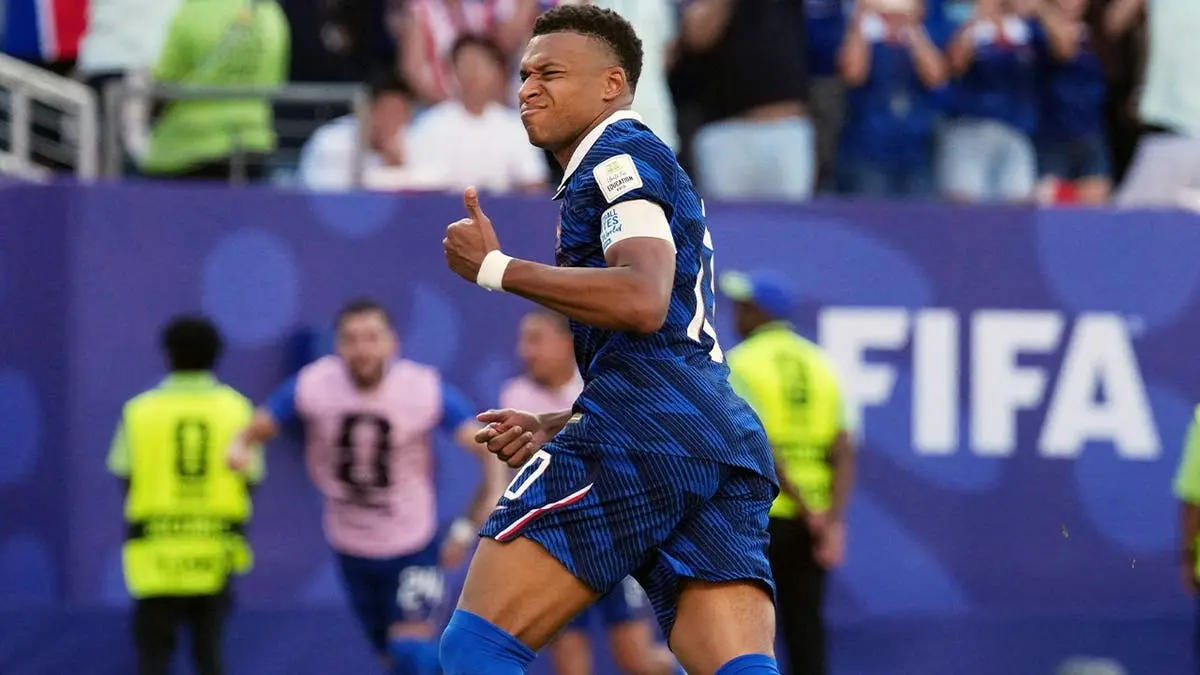 Kylian Mbappe celebrating during a France football match.