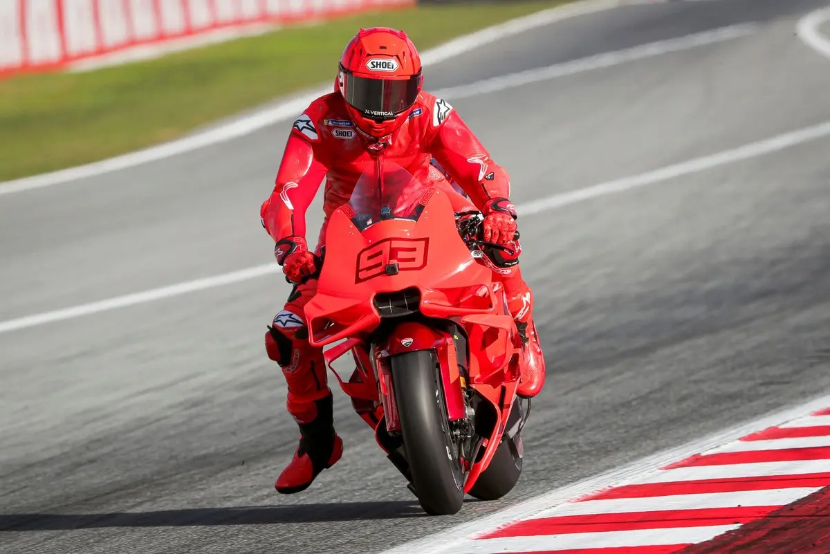 Marc Marquez riding a red Ducati Desmosedas MotoGP bike on a race track
